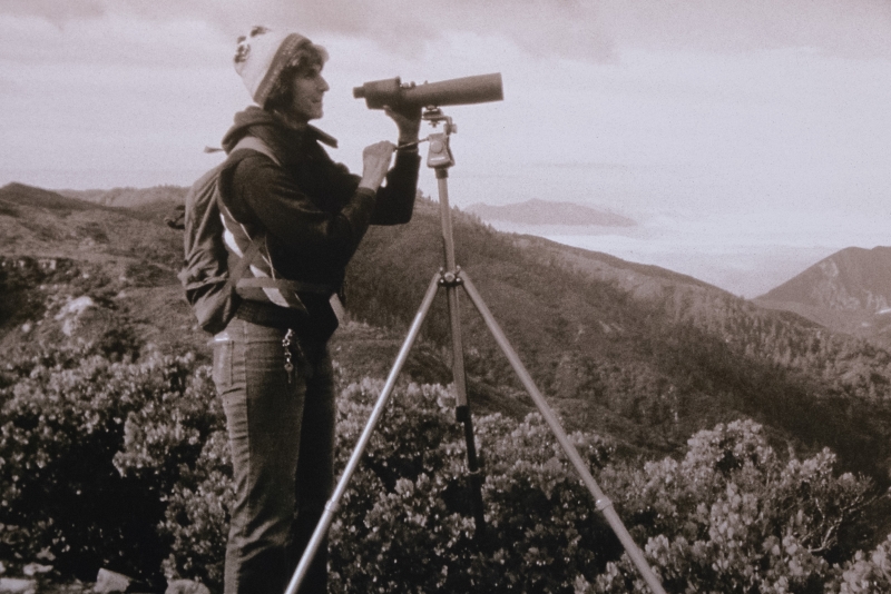 Jan Hamber with a spotting scope in the California backcountry