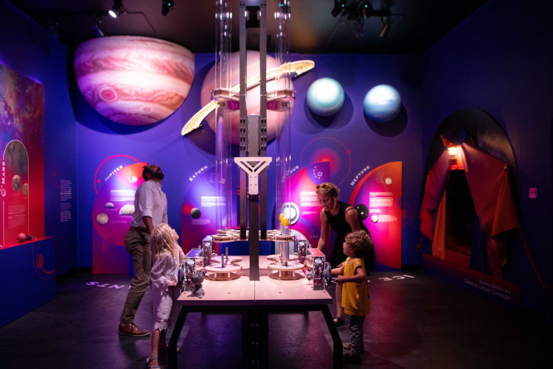 A family exploring the Santa Barbara Museum of Nartural History new exhibit Our Cosmic Coast