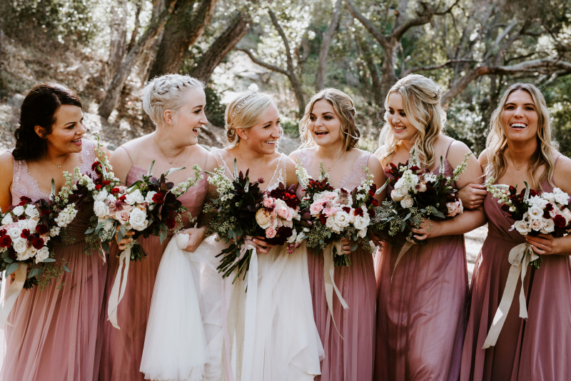 happy bridal party in an oak woodland