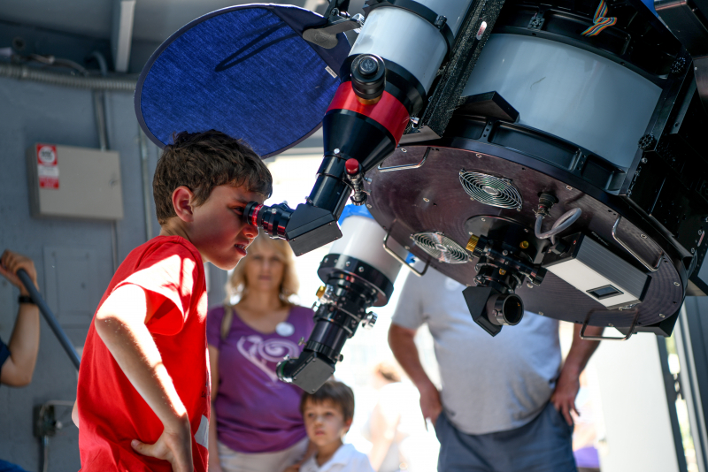 Young boy exploring the Observatory Telescope 